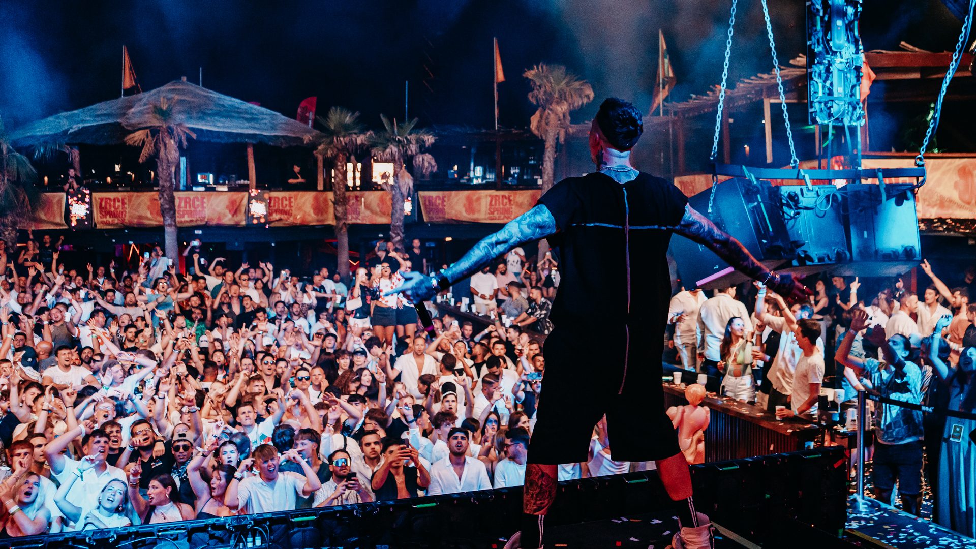 Blasterjaxx on stage with arms spread in front of a huge Zrce Spring Break crowd