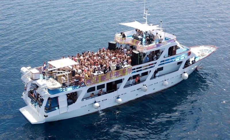 Party boat full of people on the Adriatic, seen from above