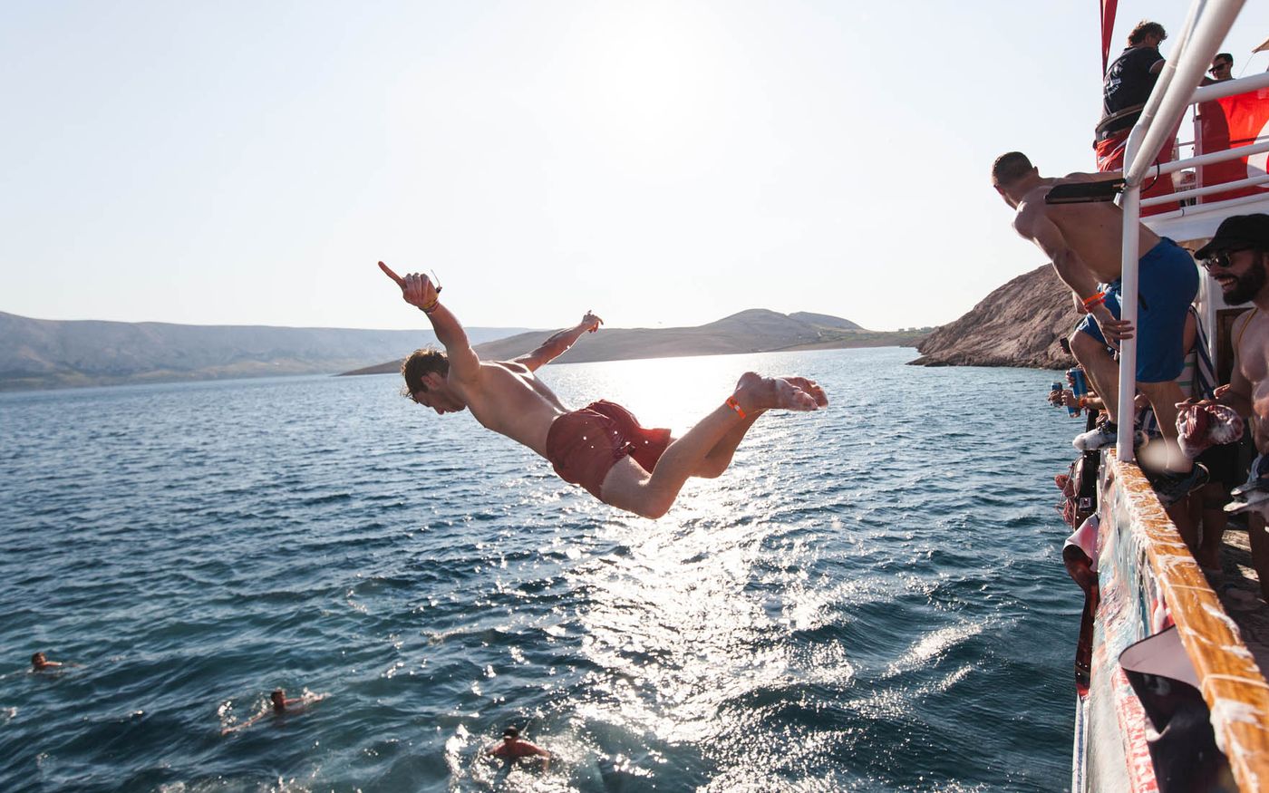 A guest diving from the party boat into the Adriatic sea