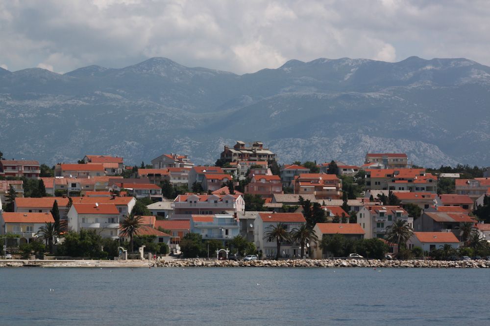 Novalja town by the sea with the Velebit mountains behind
