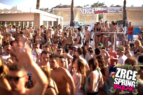 Crowd dancing in the foam at a pool party