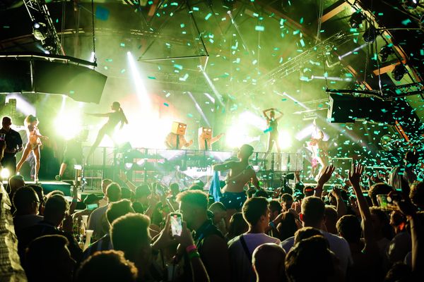 Green confetti and dancers on stage at night