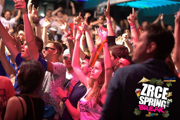 Crowd with hands up in pink light