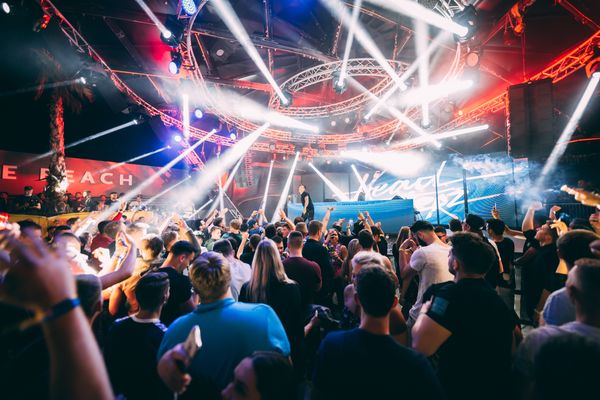 Light beams over the stage and the crowd at night
