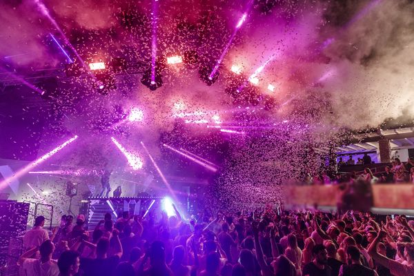Pink confetti and lasers over the dancing crowd