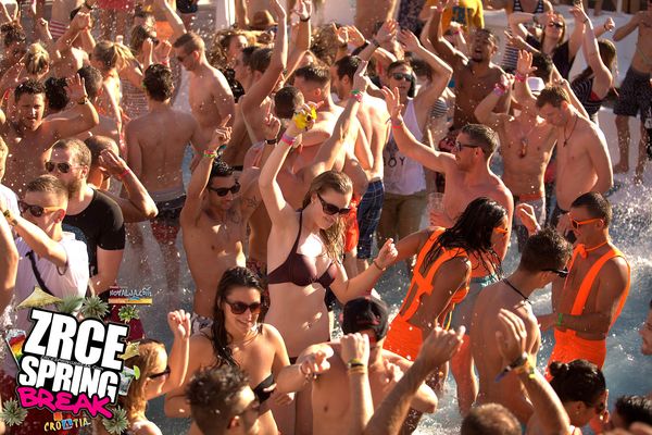 Pool party crowd dancing with arms in the air